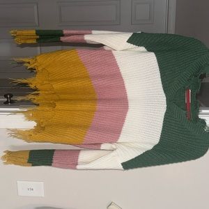 Color block sweater, fringe at bottom.